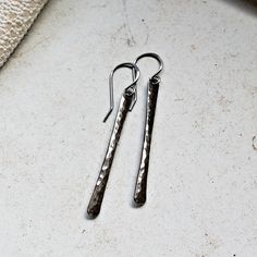 Made to order. Please refer to the shop announcement or the policies page for current production times. The newest addition to my metal bar earring family: oxidized sterling silver! The bars have been hand hammered for texture, tumbled to a beautiful shine. They are then oxidized and buffed for an aged look. The ninth picture shows differing sizes in plain sterling silver, and the last picture shows all of the stick earrings I offer. ~ oxidized sterling silver wire and ear wires ~ choose between Hand Forged Dangle Earrings As Gift, Hand Forged Long Drop Earrings For Everyday, Classic Hammered Drop Earrings, Hand Forged Drop Earrings As Gift, Hand Forged Dangle Earrings For Everyday, Silver Bar Earrings, Oxidized Silver Earrings, Stick Earrings, The Last Picture Show