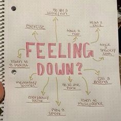 a notepad with writing on it that says feeling down and arrows pointing in different directions