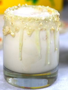 two glasses filled with white liquid on top of a table