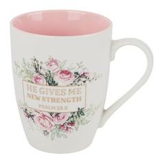 a white coffee mug with pink roses on it and the words, give me new strength