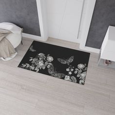 a black and white rug with flowers on it