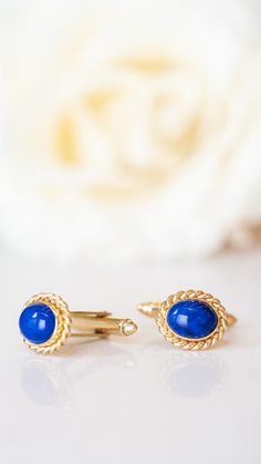 These Modern cufflinks are made with lapis lazuli and 18k yellow gold. The lapis pieces are smooth, oval cabochons that are bordered by a frame of twisted gold wire. The buttery yellow gold provides a striking contrast to the vibrant blue of the gemstones. Composition: 18 Karat Yellow Gold, 14 Karat Yellow Gold Primary Stone: Natural Lapis Lazuli Shape and Measurements: 7.5 mm x 3.5 mm (10) General Characteristics:  Height Above Finger: 14 mm x 12 mm Era: Modern 1970-Present -- ALL PIECES ARE SU Oval Yellow Gold Jewelry For Business, Formal Lapis Lazuli Jewelry, Luxury Oval Lapis Lazuli Jewelry, Formal Yellow Gold Jewelry With Lapis Lazuli, Formal Yellow Gold Lapis Lazuli Jewelry, Luxury Lapis Lazuli Cabochon Jewelry, Elegant Lapis Lazuli Jewelry For Formal Occasions, Elegant Formal Lapis Lazuli Jewelry, Elegant Lapis Lazuli Oval Cabochon Jewelry