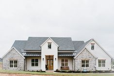 a white house with gray shingles and windows