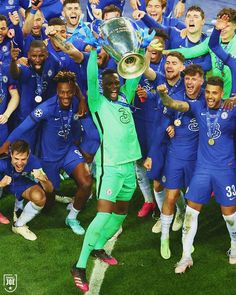 the soccer team is celebrating with their trophy