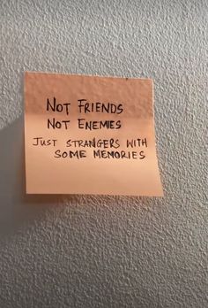 a sticky note attached to a refrigerator with the caption not friends not enemys just strangers with some memories