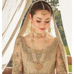 a woman in a bridal gown with jewelry