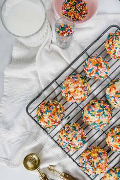 sprinkle covered cookies cooling on a wire rack