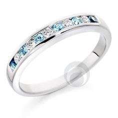 a white gold ring with blue and clear stones