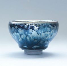 a blue and white bowl sitting on top of a table