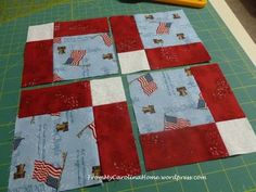 four quilts laid out on top of a cutting board