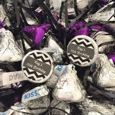 chocolate candies wrapped in foil and tied to ribbons with name tags on them for birthdays