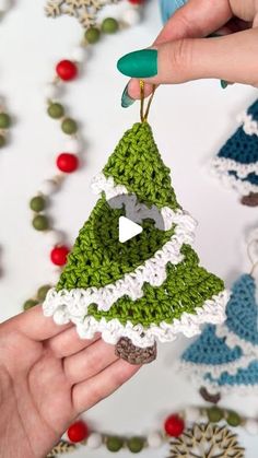 crocheted christmas tree ornament being held by two hands