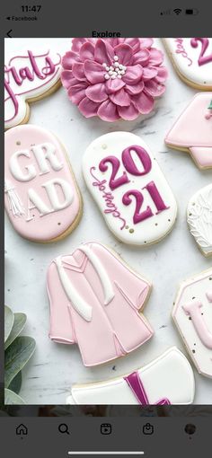 decorated cookies with pink and white icing on a table