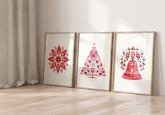 three framed christmas cards on the floor in front of a window