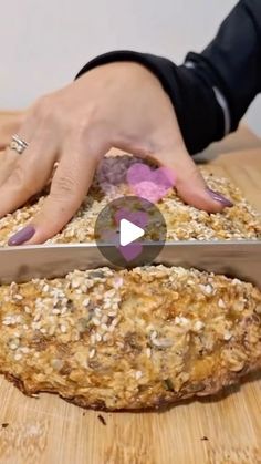 a person is cutting something with a knife on a wooden table that has grain in it