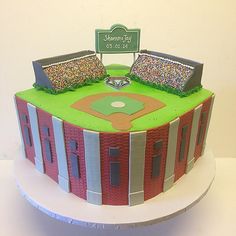 a baseball field cake is decorated with multicolored icing