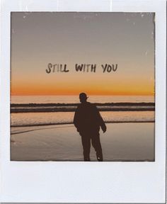 a man standing on top of a beach next to the ocean at sunset with words still with you