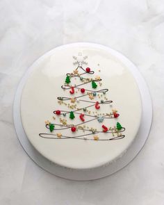 a white plate with a decorated christmas tree on it