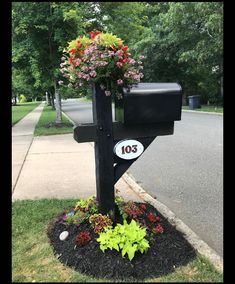 a mailbox with flowers growing out of it