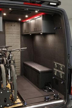 a bike is parked in the back of a vehicle with its cargo compartment open and it's lights on