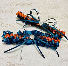 two blue and orange garters with bows on them