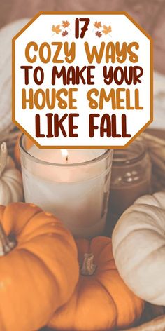 a basket filled with lots of pumpkins next to a white candle and some candles