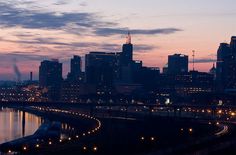 the city skyline is lit up at night