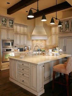 a large kitchen with an island in the middle