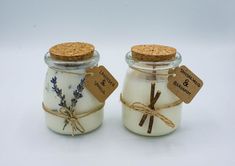 two jars with labels on them sitting next to each other, one containing lavender and the other containing cinnamon sticks