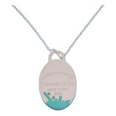 Brand: Tiffany & Co.  Hallmark: Tiffany & Co. Ag925   Material:  sterling silver and enamel  Measurements: adjustable chain: 28 - 30" long x 0.10" thick      Pendant: 1.60" long x 90" wide x 0.11" high  Weight:  17.5 grams    This long elegant authentic necklace is by Tiffany & Co. from Please Return to Tiffany & Co. Collection. It is crafted from sterling silver with a fine polished finish featuring a flat long oval shape pendant with Tiffany's green enamel splashed on the lower end of the pend Oval Engraved Enamel Necklace, Tiffany Green, Return To Tiffany, Tiffany And Co, Bead Chain, Green Enamel, Oval Pendant, Beaded Chain, Tiffany & Co.