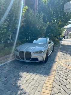 a silver sports car is parked on the street