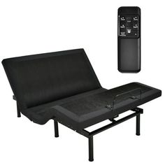 a black futon bed with a remote control next to it's side view