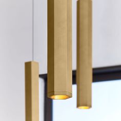 three gold colored lights hanging from the ceiling