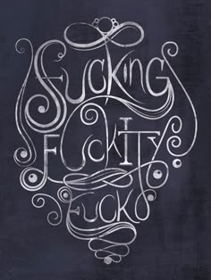 the words suckling city are drawn in chalk on a blackboard with swirls