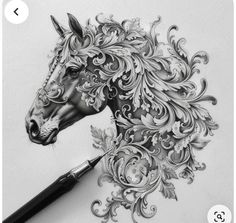 a drawing of a horse's head with flowers and leaves on it, next to a pen