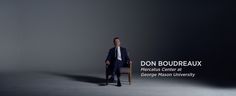 a man sitting in a chair with the words don boudreaauxx on it