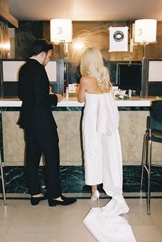 a man and woman standing in front of a counter