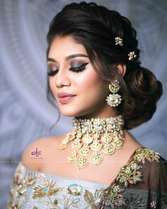 a woman wearing an elaborate necklace and earrings