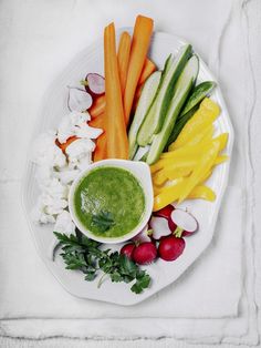 a white plate topped with veggies and dip