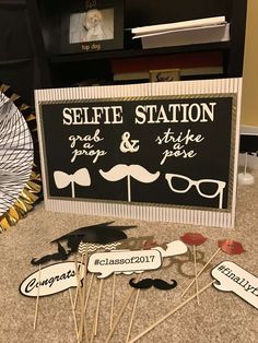 there are many signs that say selfie station and some have mustaches on them