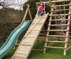 two children are playing on a wooden slide