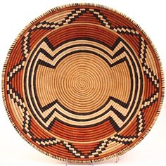 a brown and black woven basket sitting on top of a table