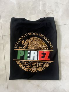 Show off your Mexican pride with this custom made Mexico shirt. May be personalized with a name of your choosing or a preferred state name.  Long Sleeve T-Shirts, Sweatshirts and/or Hoodies are also available. Just send us a message and we will happily make it happen. If you need your item by a certain date please contact me so that we can work with you. If you have any problem with your order please feel free to contact us. T-Shirt:  Gildan Soft Style G6400 Solid Colors:4.5 oz/sq yd, 100% Ring Fan Merchandise Tops With Custom Logo And Crew Neck, Fan Merchandise Crew Neck Tops With Custom Logo, Customizable Crew Neck Shirt For Fans, Mexican Names, Mexican Eagle, Mexico Shirt, Mexican Pride, Mexican Shirt, Mexico Shirts