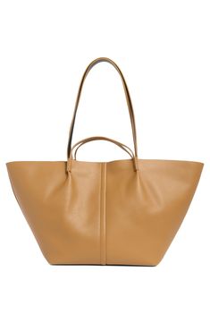 Made of smooth durable leather, this large tote bag features handle straps and shoulder straps for versatility of wear with a soft cotton lining and zip pouch. 23.5"W x 11.5"H x 6.75"D; 3" handle drop; 12" shoulder strap drop Cotton lining Leather Imported On-the-go Tote Shoulder Bag With Top Carry Handle, Modern Beige Bags With Rolled Handles, Classic Faux Leather Shopping Bags, Spring Tote Satchel For Daily Use, Spring Faux Leather Tote Bag, Classic Crossbody Hobo Bag For Shopping, Leather Bucket Bag For On-the-go Use In Fall, Classic Soft Leather Shoulder Bag For Shopping, On-the-go Satchel With Double Handle