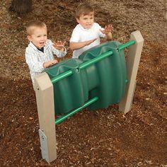 two young boys playing in a green plastic play set at the park with their hands together