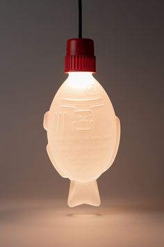 a light bulb shaped like a plastic bottle with a red cap hanging from it's side