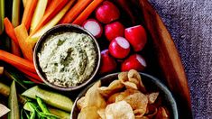 an assortment of vegetables and dips on a platter