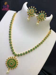 Simple and elegant American diamond gold plated necklace earring set from the house of Indian Designs. length of the necklace with chain is 15 inches and plus a 3 inch extender. Gold Emerald Jewelry Sets For Celebration, Green Jewelry With Simple Design As Gift, Simple Green Jewelry For Gifts, Green Simple Design Jewelry For Gift, Simple Green Jewelry Gift, Green Simple Design Jewelry Gift, Green Gold Plated Necklaces For Celebration, Green Gold Plated Necklace For Celebration, Green Gold-plated Necklaces For Celebration