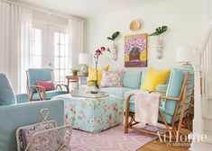 a living room filled with lots of furniture and flowers in vases on the wall