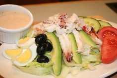 a white plate topped with salad and dressing